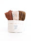Six-piece face towel set by Sweet July Skin in a fabric basket with brand label visible.