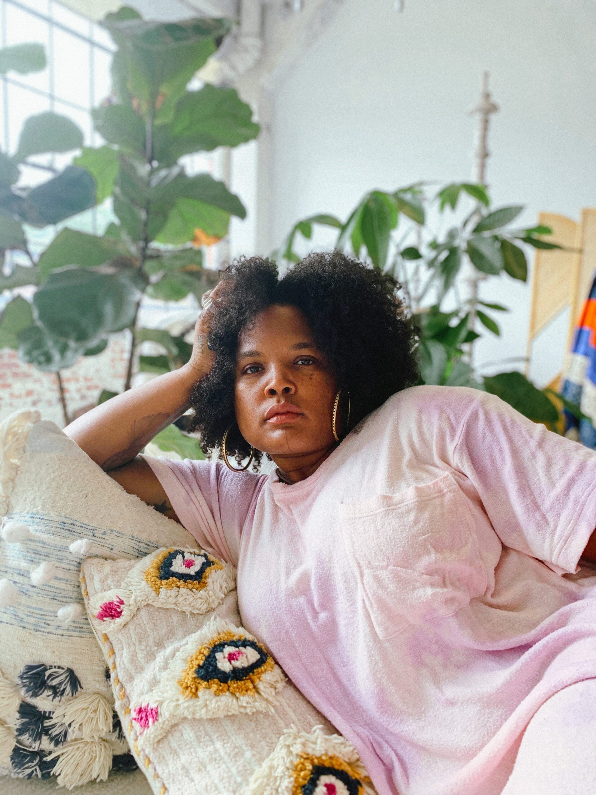 Beatrice Dixon of The Honey Pot Co. lounges serenely, exuding calm confidence and a down-to-earth vibe.
