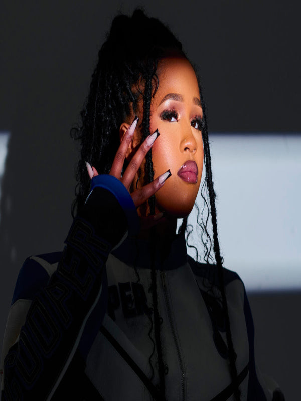 Confident Pabi Cooper poses with a modern, stylish look, embodying the vibrant energy of Amapiano music.
