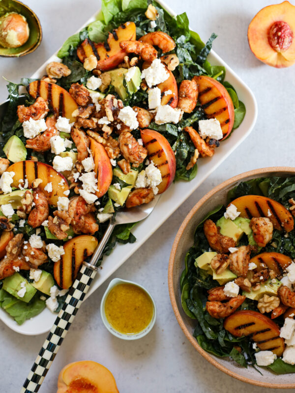 Vibrant grilled peach salad with shrimp, avocado, and feta, showcasing summer's bounty in a fresh, enticing, and accessible way.
