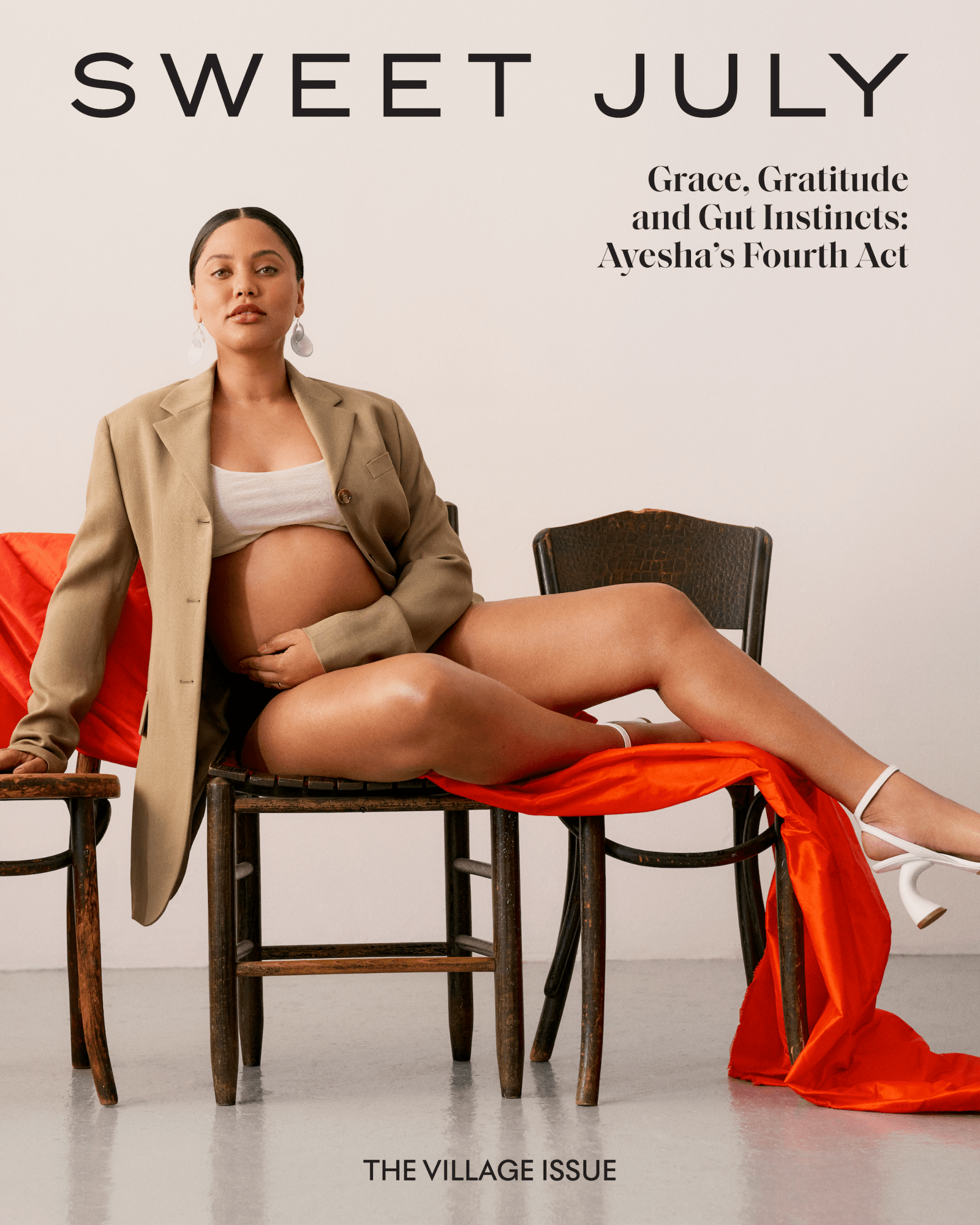 Ayesha Curry radiates confidence in a magazine cover, pregnant and draped in a tan blazer and orange fabric.
