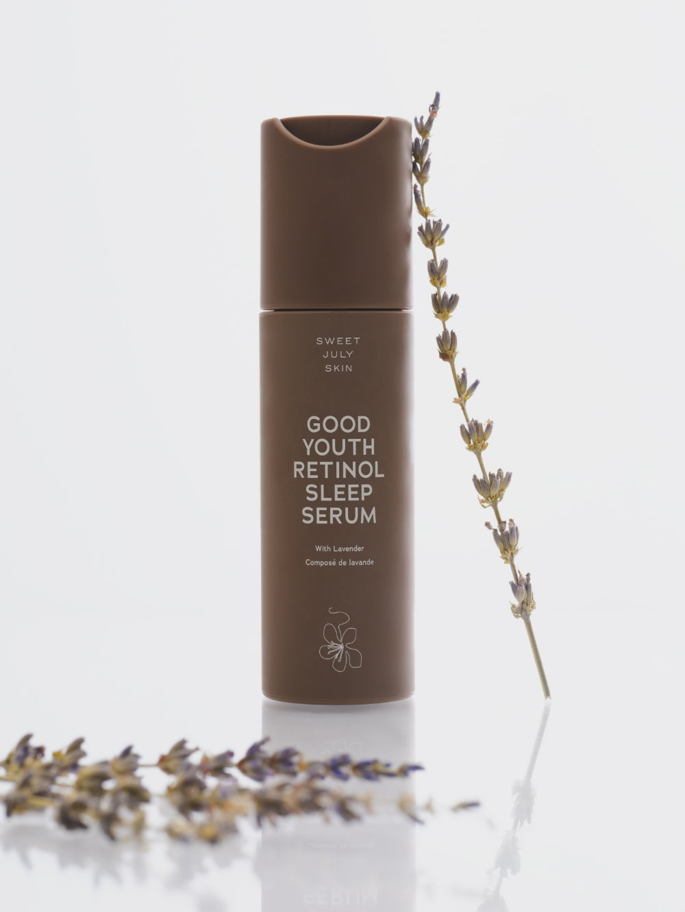 Brown retinol sleep serum by Sweet July Skin with a lavender sprig.