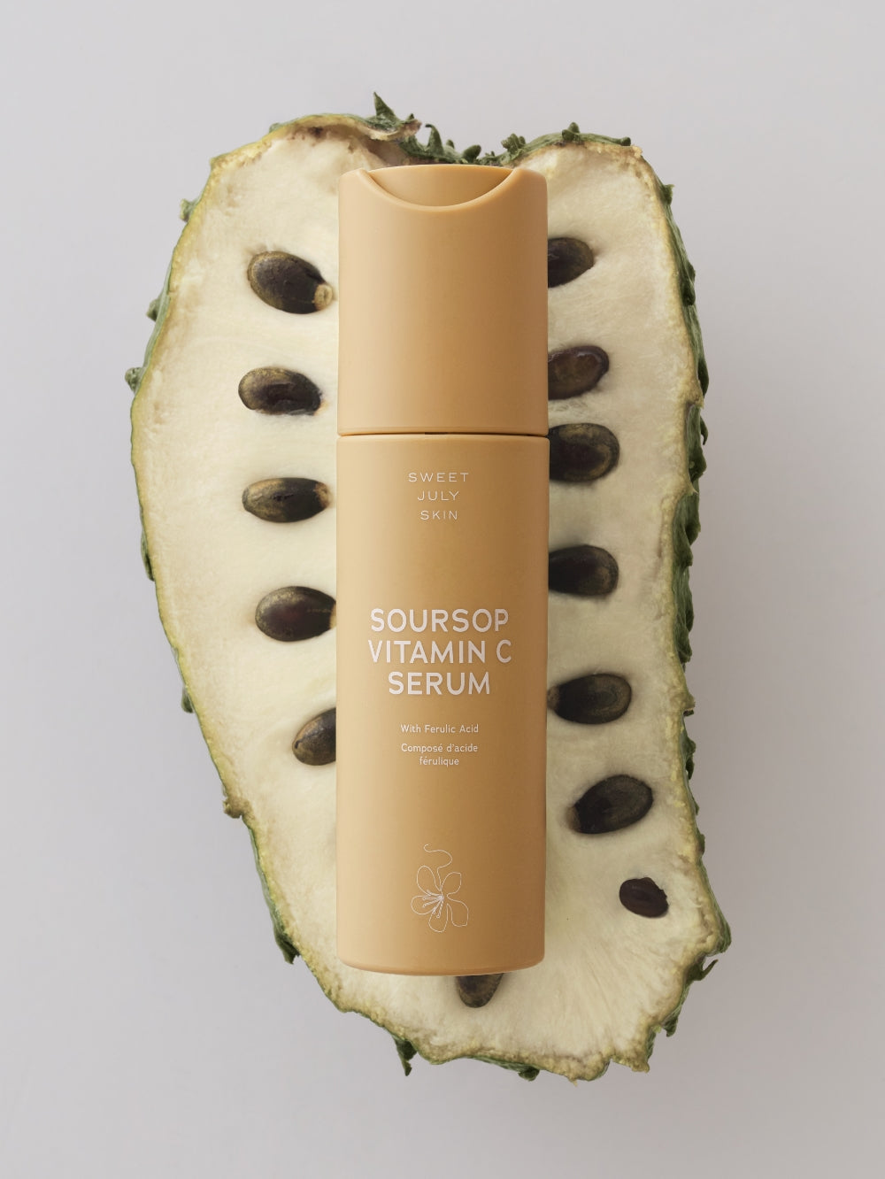 Tan Vitamin C serum by Sweet July Skin on a cut soursop.