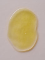 Yellow vitamin C and retinol serum by Day + Night set, with a shiny wet appearance.