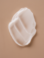 White cream smear on a tan backdrop.