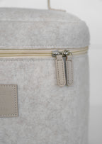 Beige vanity bag by Sweet July Skin, featuring a cream-colored zipper and a felt-like texture.