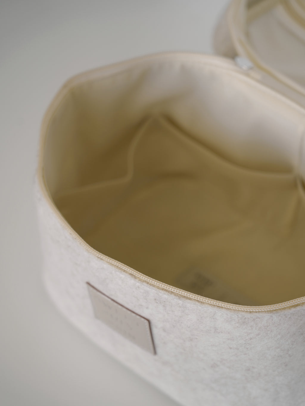 Beige vanity bag by Sweet July Skin, showing an open interior with a small pocket.