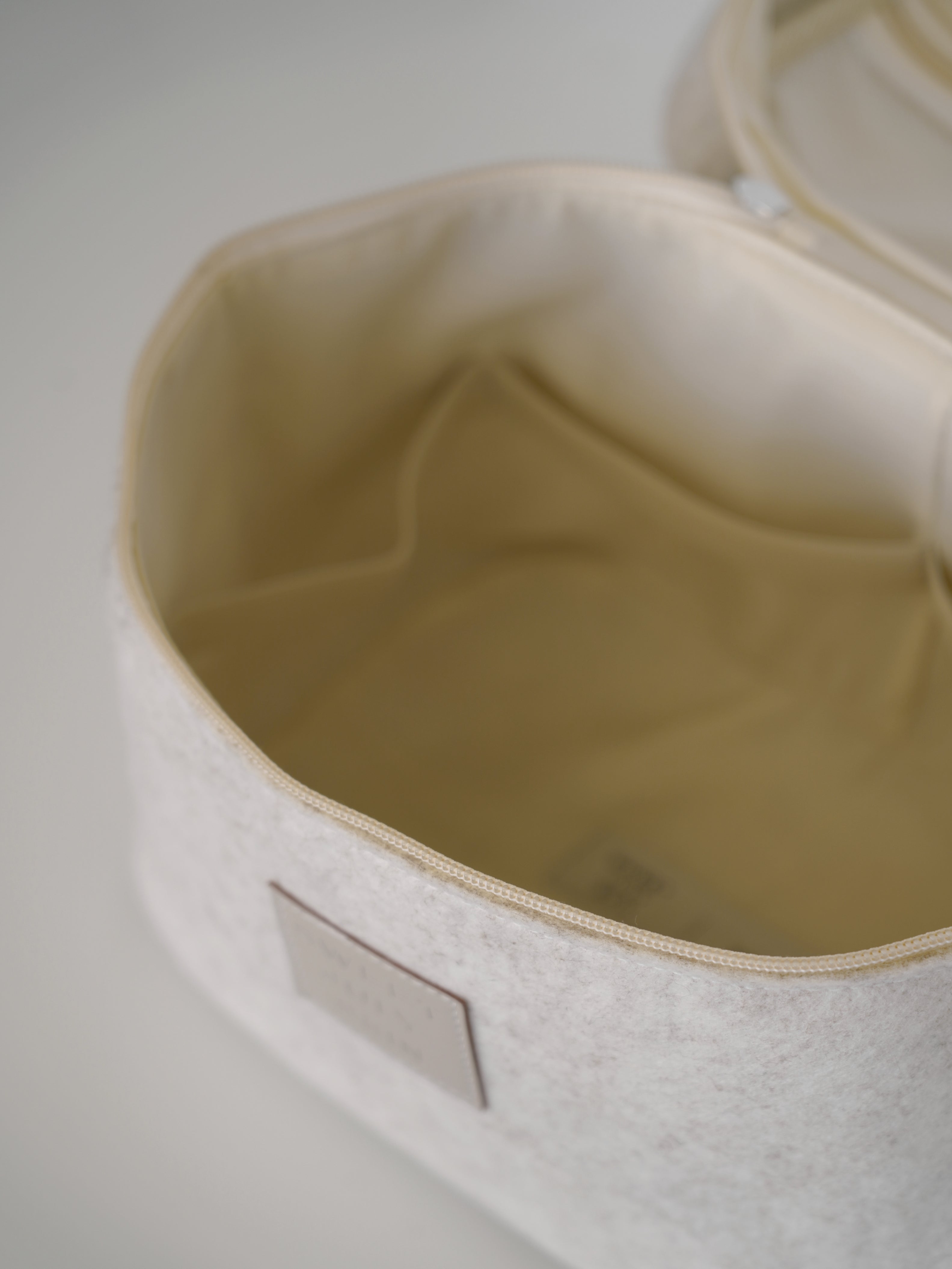 Beige vanity bag by Sweet July Skin, showing an open interior with a small pocket.