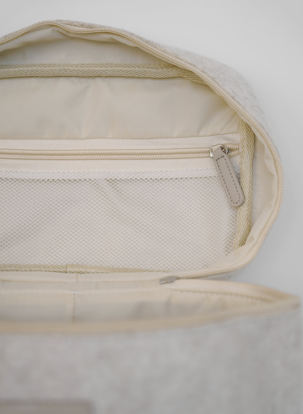 Open beige vanity bag by Sweet July Skin, featuring a mesh pocket and zippered closure.