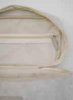 Open beige vanity bag by Sweet July Skin, featuring a mesh pocket and zippered closure.