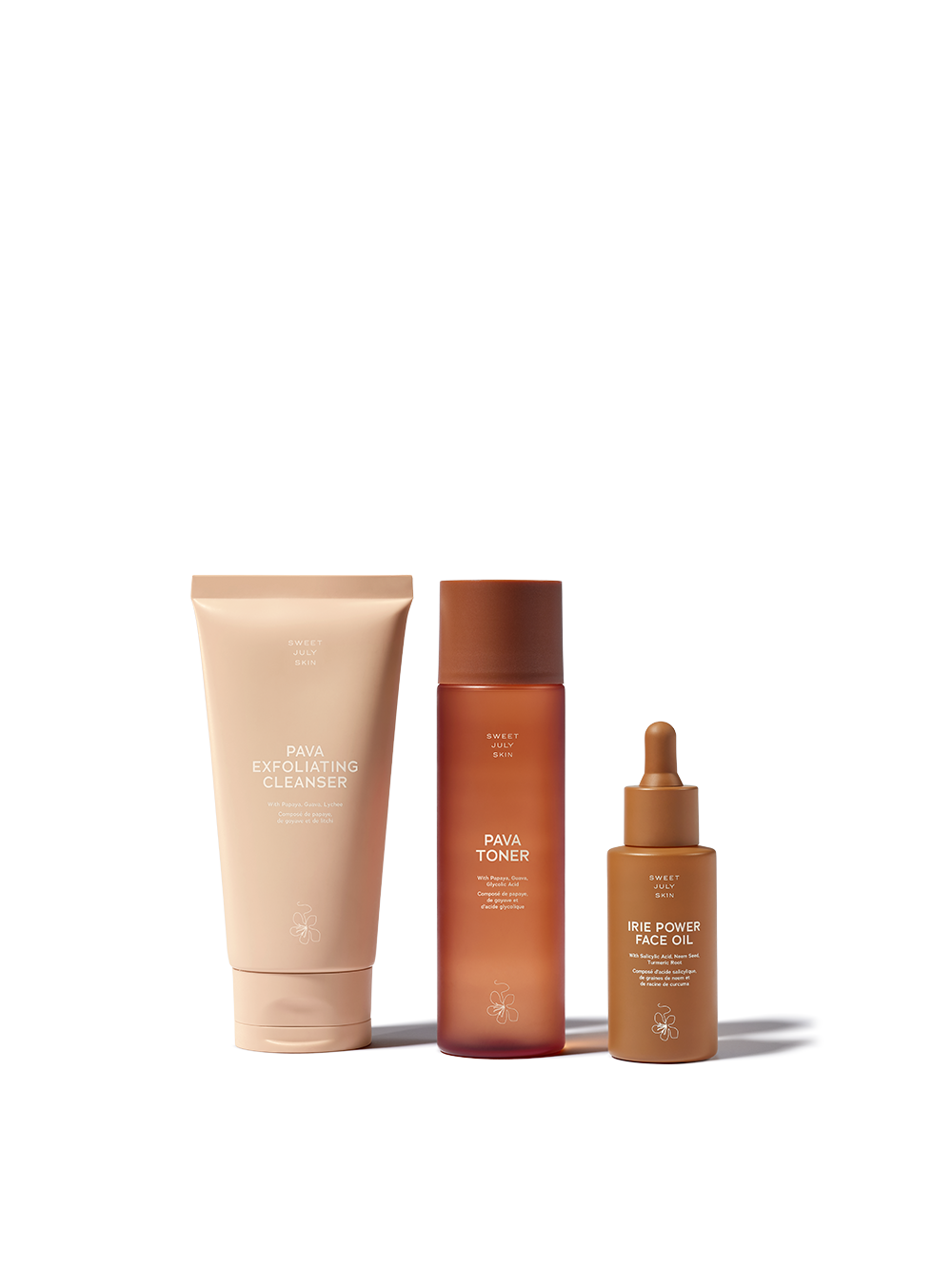 Skincare set by Sweet July Skin, including a cleanser, toner, and face oil, in brown packaging.