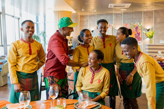 The photo is of a group of people in matching outfits, possibly at a wedding or event.