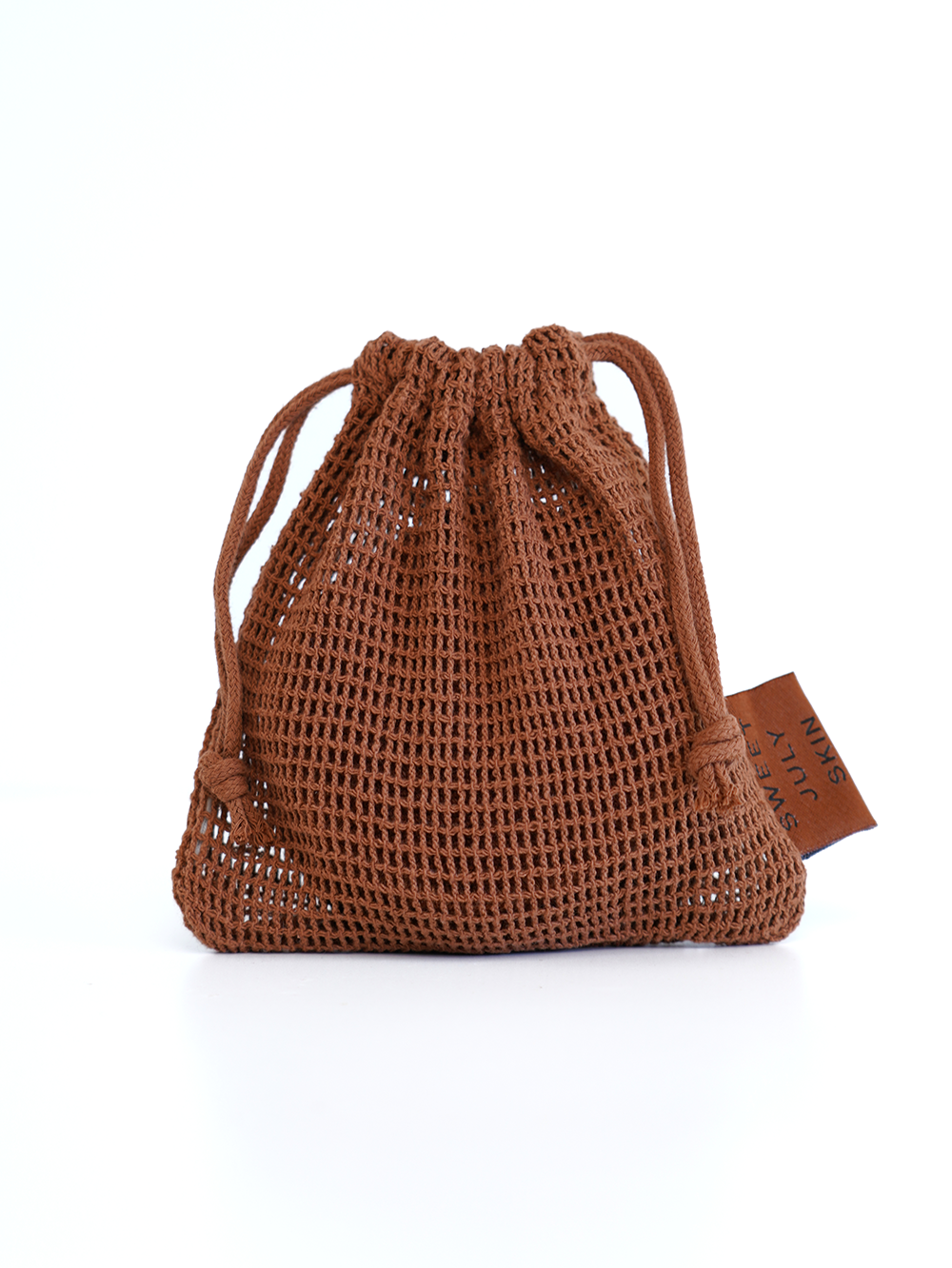 Brown crocheted reusable face rounds bag by Sweet July Skin with drawstring closure.