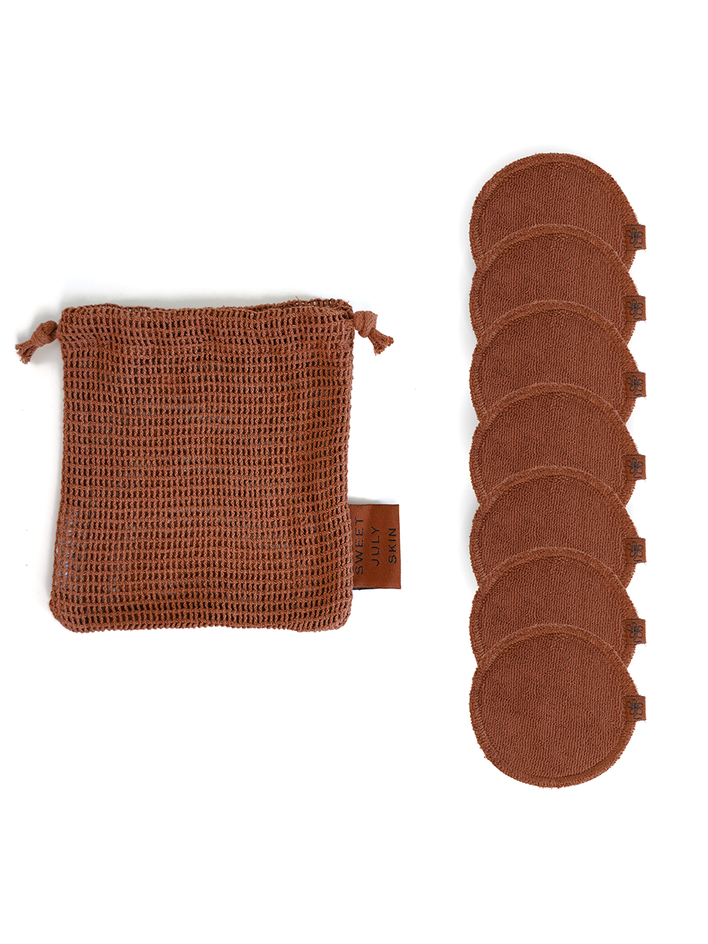 Reusable face rounds by Sweet July Skin with a matching drawstring bag, isolated on a white background.