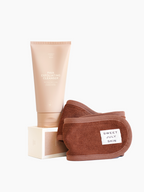 Exfoliating cleanser with brown spa headband by Sweet July Skin on top of matching cleanser box.