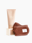Exfoliating cleanser with brown spa headband by Sweet July Skin on top of matching cleanser box.
