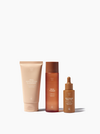 Skincare essentials set by Sweet July Skin featuring a cleanser, toner and face oil.