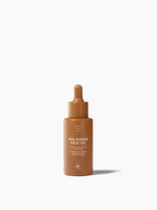 Brown glass bottle of face oil by Sweet July Skin with a dropper top.