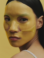 Model wears Pineapple Punch Hydrating Face Mask with yellow background