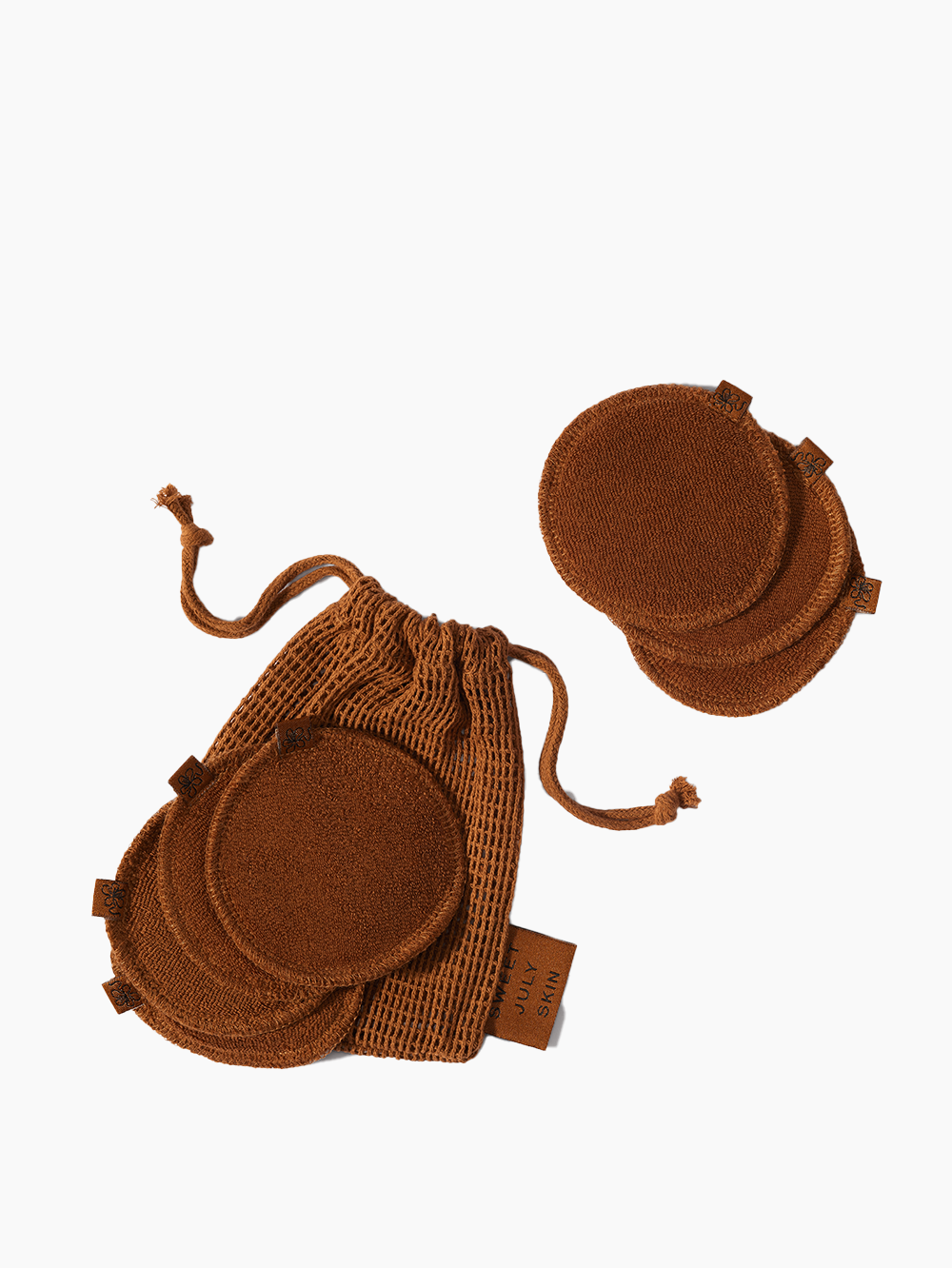 Brown reusable face rounds by Sweet July Skin in a matching mesh drawstring bag.
