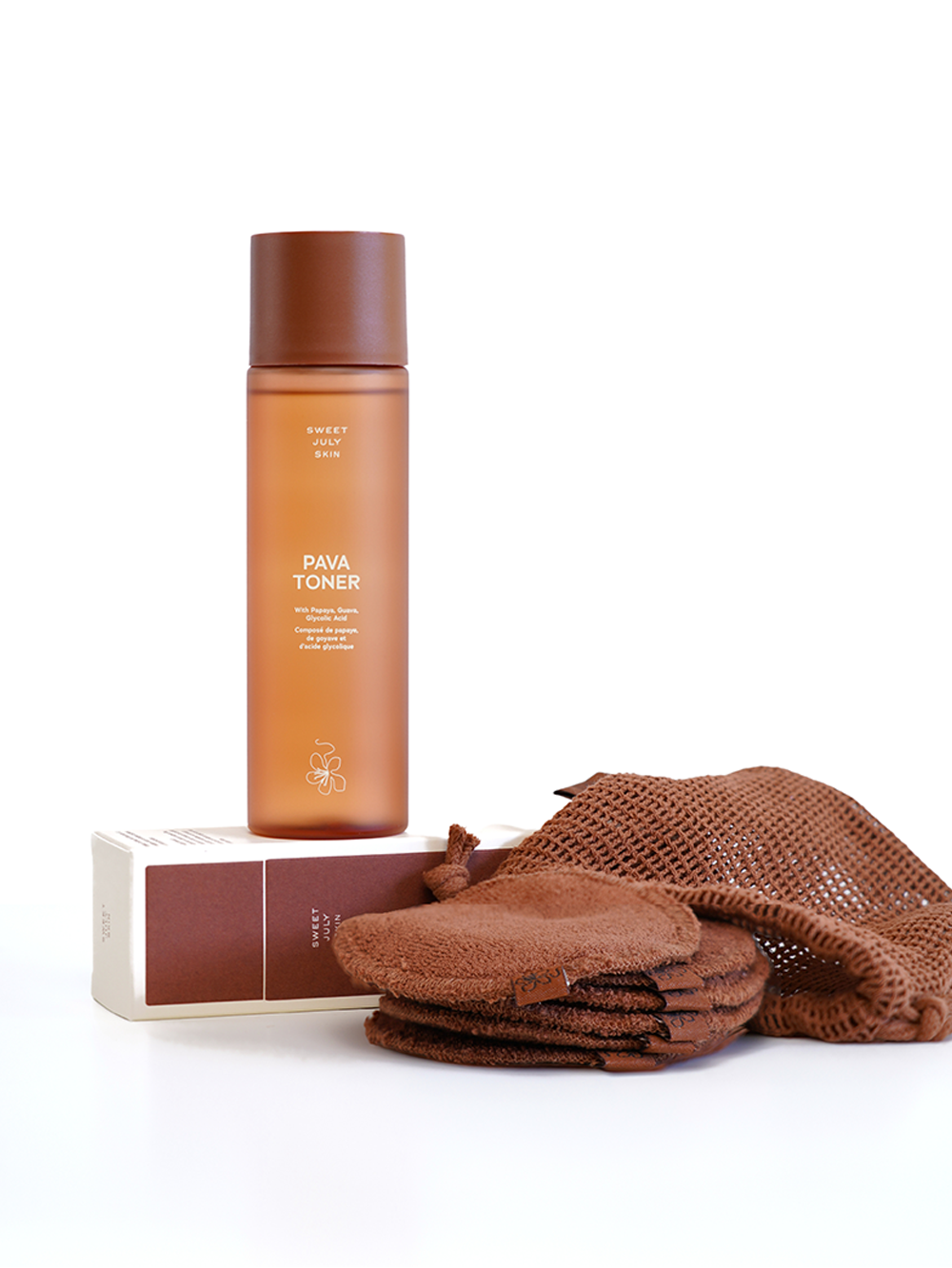 Facial toner by Sweet July Skin, presented with a stack of reusable brown cotton rounds and mesh bag.
