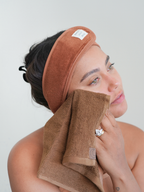 Brown face towel by Sweet July Skin, covering a woman's face, with a matching brown headband.