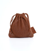 Brown net bag by SWEET JULY SKIN with drawstring closure and brand tag.