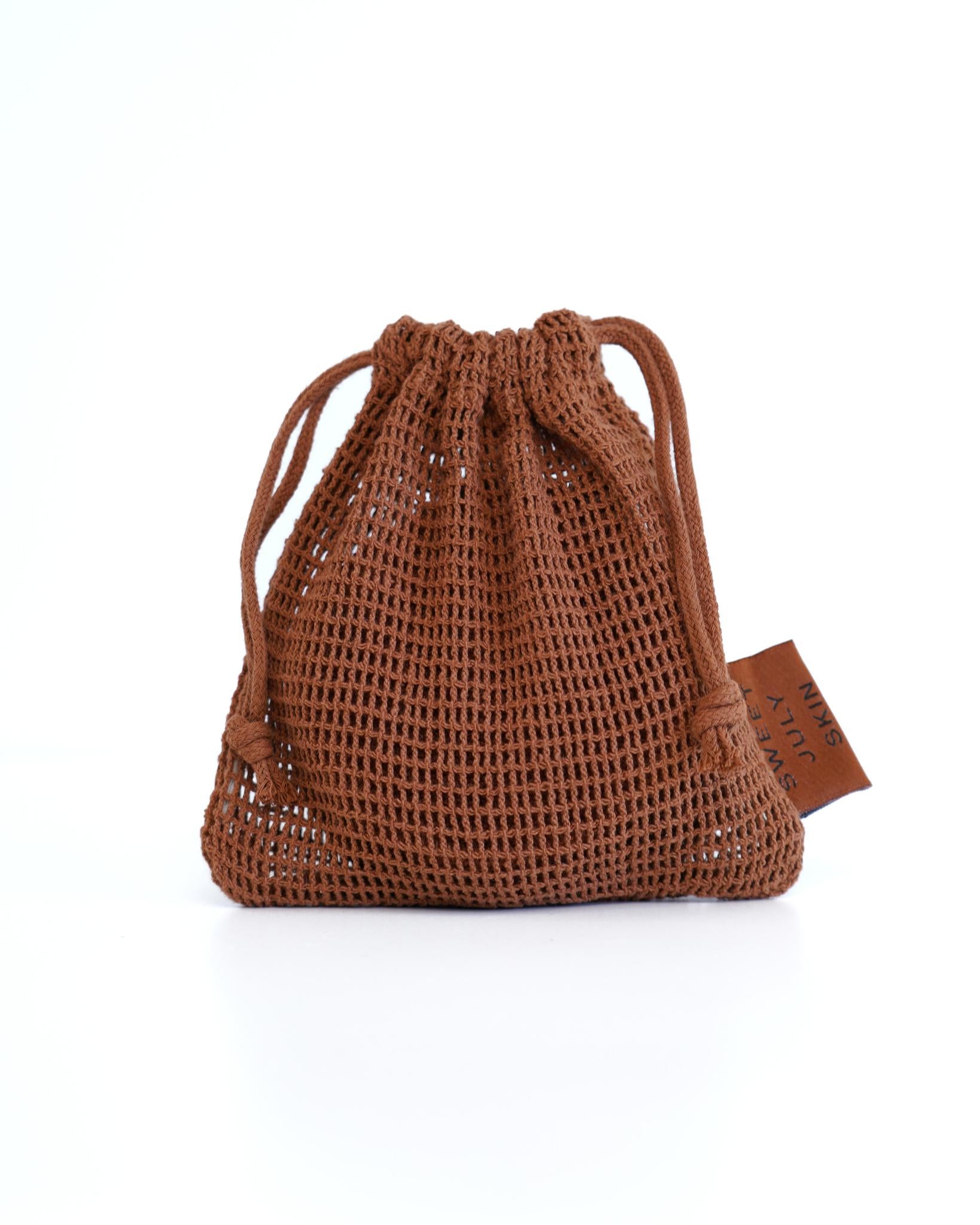 Brown net bag by SWEET JULY SKIN with drawstring closure and brand tag.