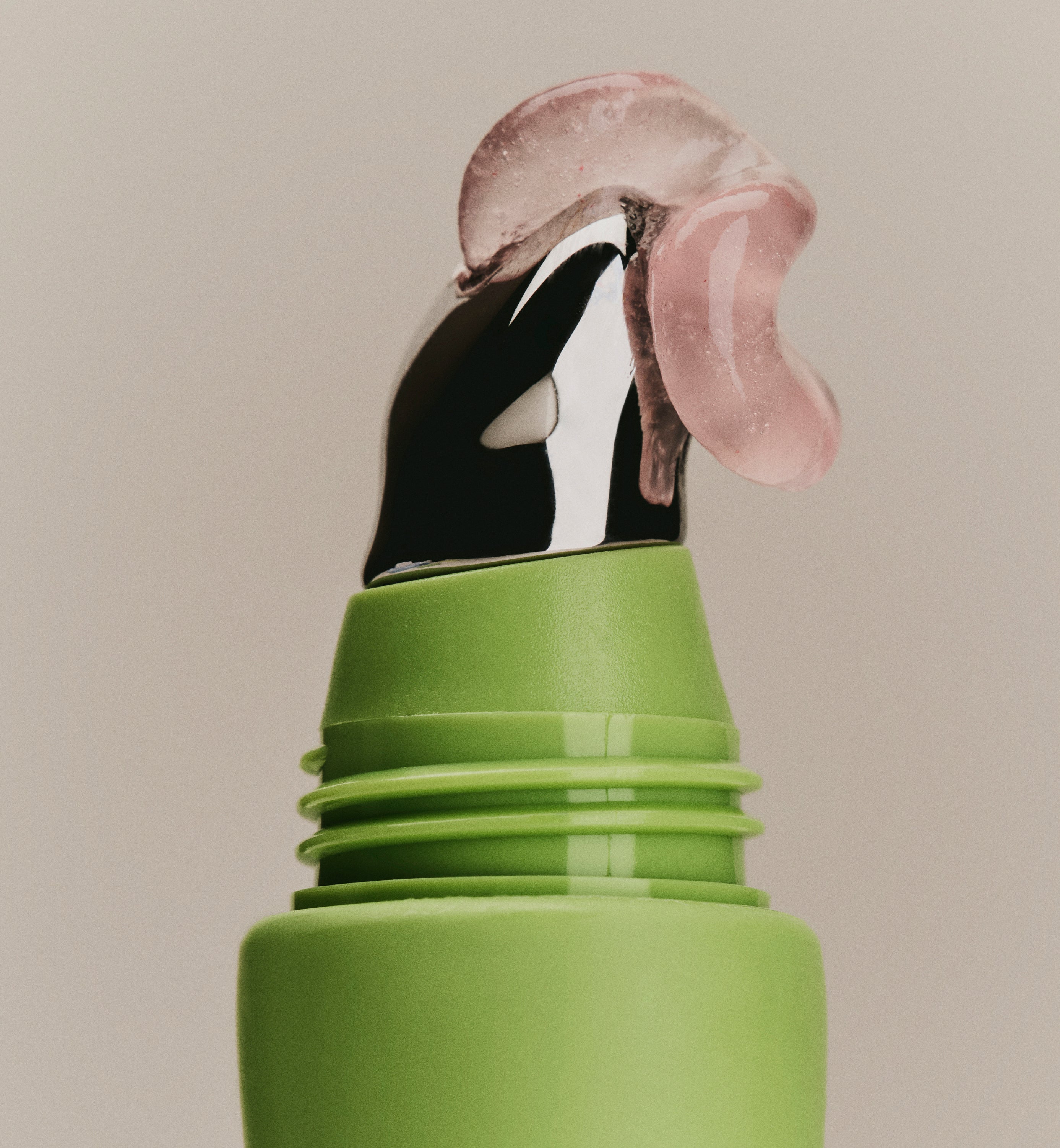 Close up of Sweet July Skin guava jelly hydrating lip treatment dispensing from metal applicator